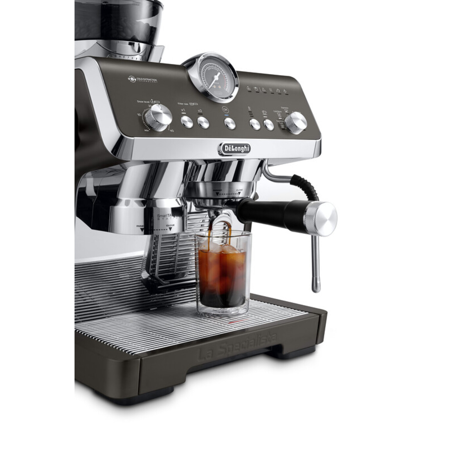 Delonghi espresso machine. Dark color scheme. Glass with espresso being poured. Silver accents.