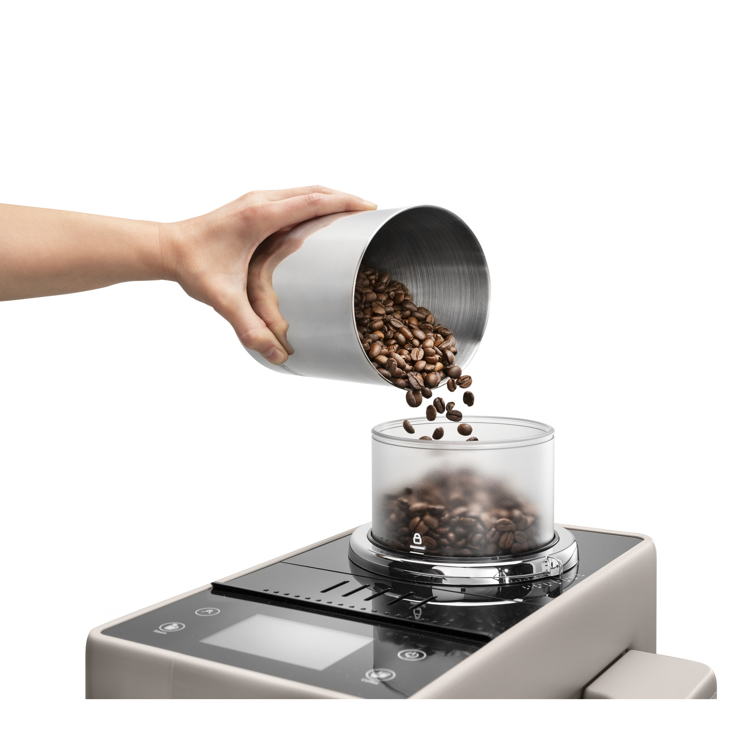 Hand pouring coffee beans into a transparent container. Coffee grinder in the bottom.