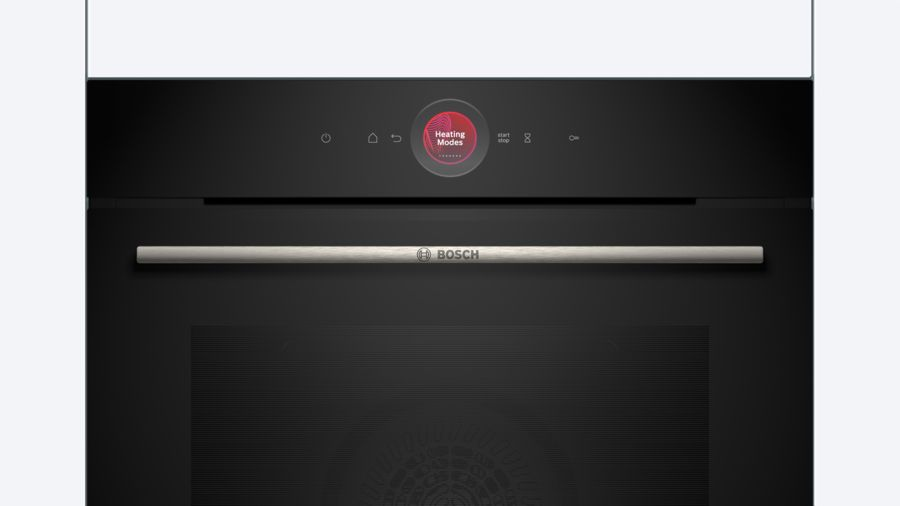 Primer plano de un horno negro con pantalla digital. Texto: Modos de calentamiento. Abajo, un asa plateada.