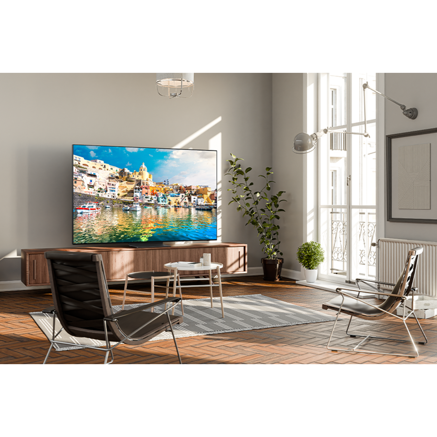A modern living room with a TV displaying a scenic view, and two chairs.