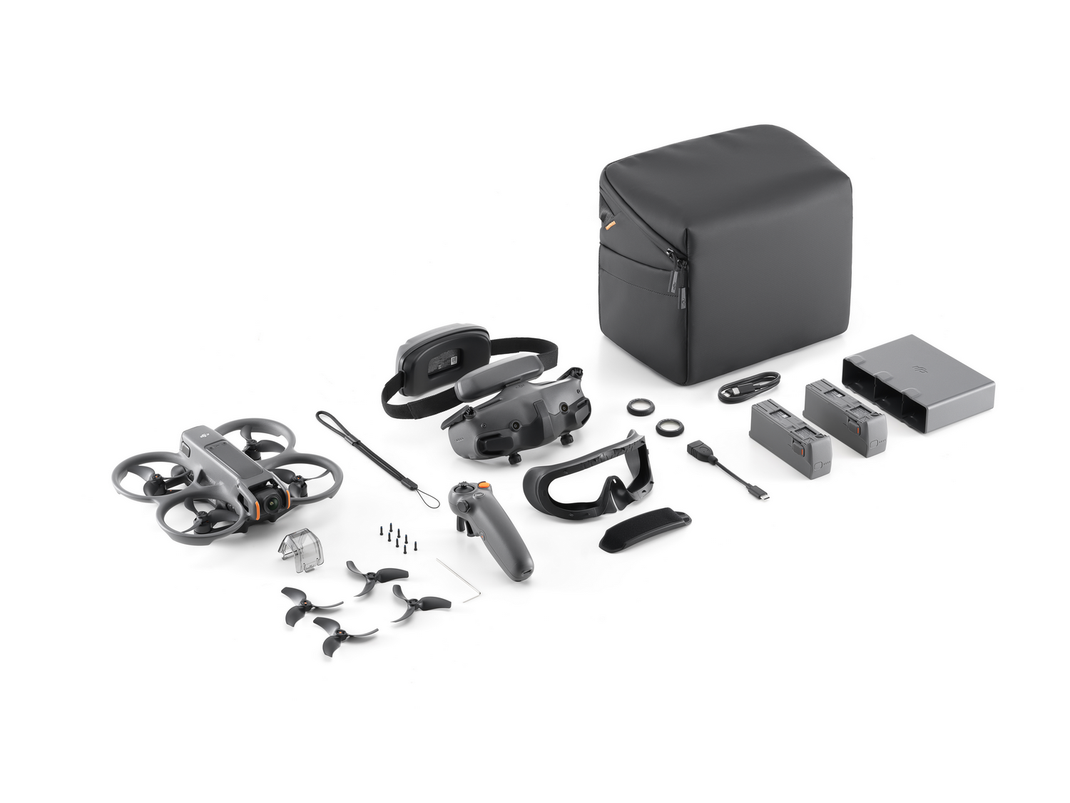Componentes del kit de drones, incluyendo dron, gafas, batería y accesorios.