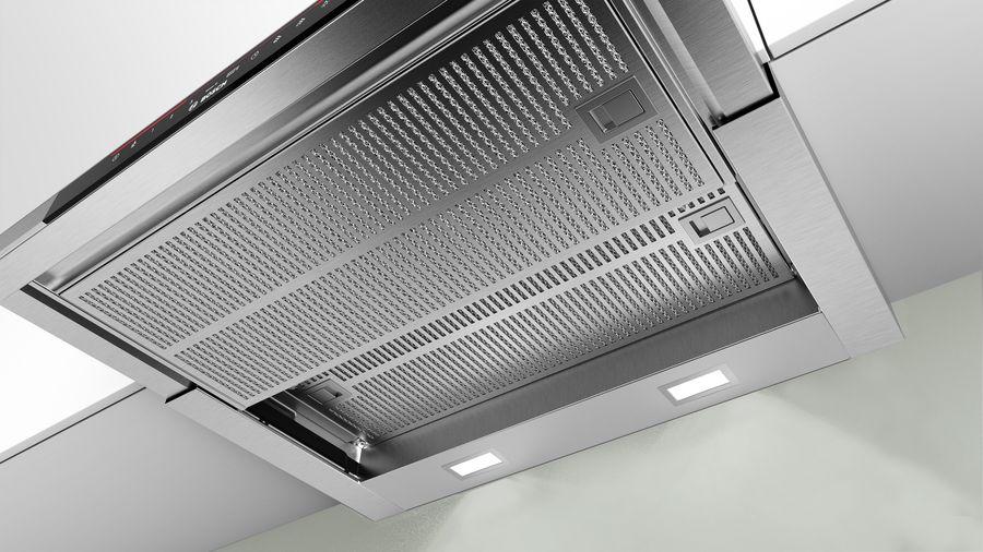 Una campana extractora de acero inoxidable con luces y un filtro de malla.