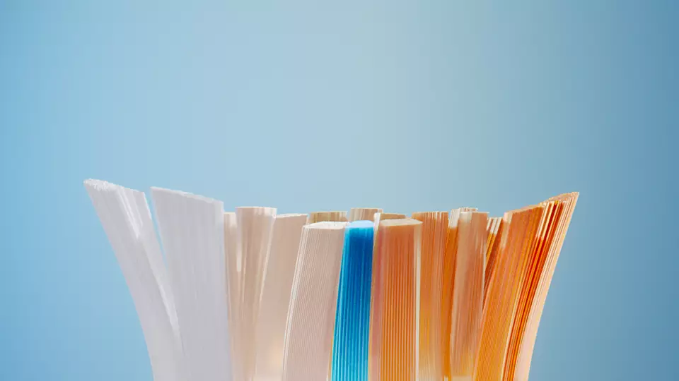 Un primo piano dei bordi di carta colorati, con una striscia blu al centro del mucchio.