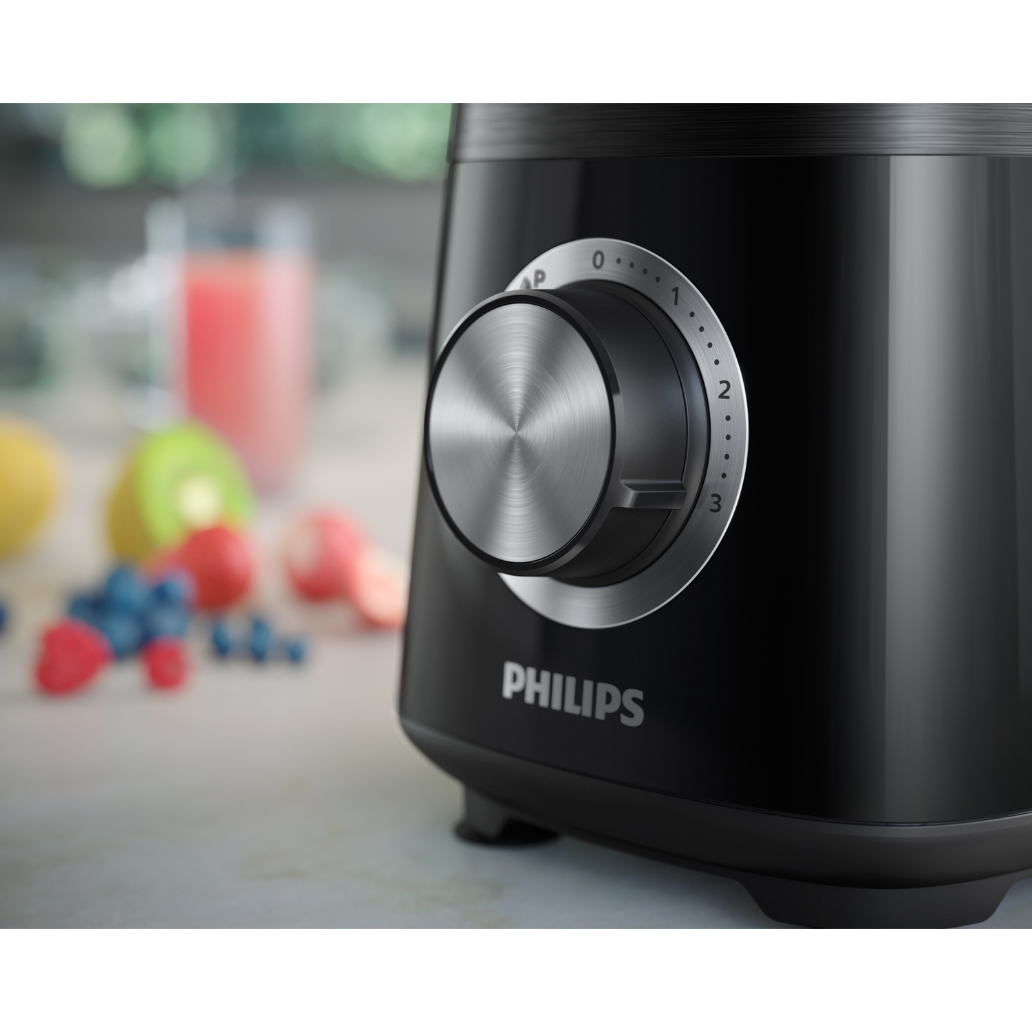 Black Philips blender with a silver dial. Fruits visible in the background.