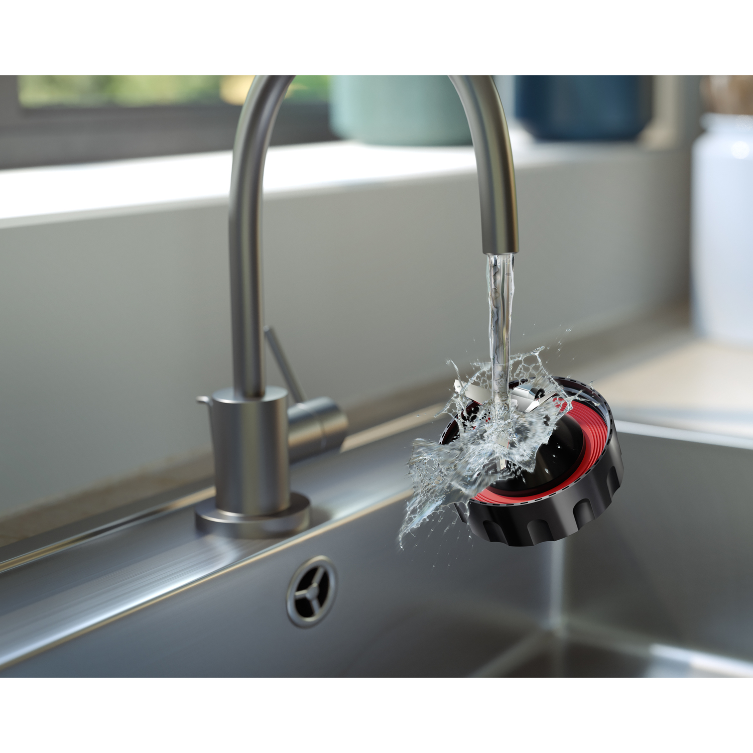 Water splashing from a faucet onto a black and red object in a sink.