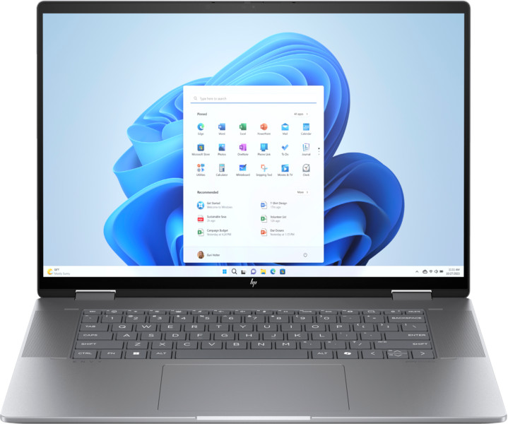 A silver laptop with open screen showing Windows 11 interface, with icons and search bar.