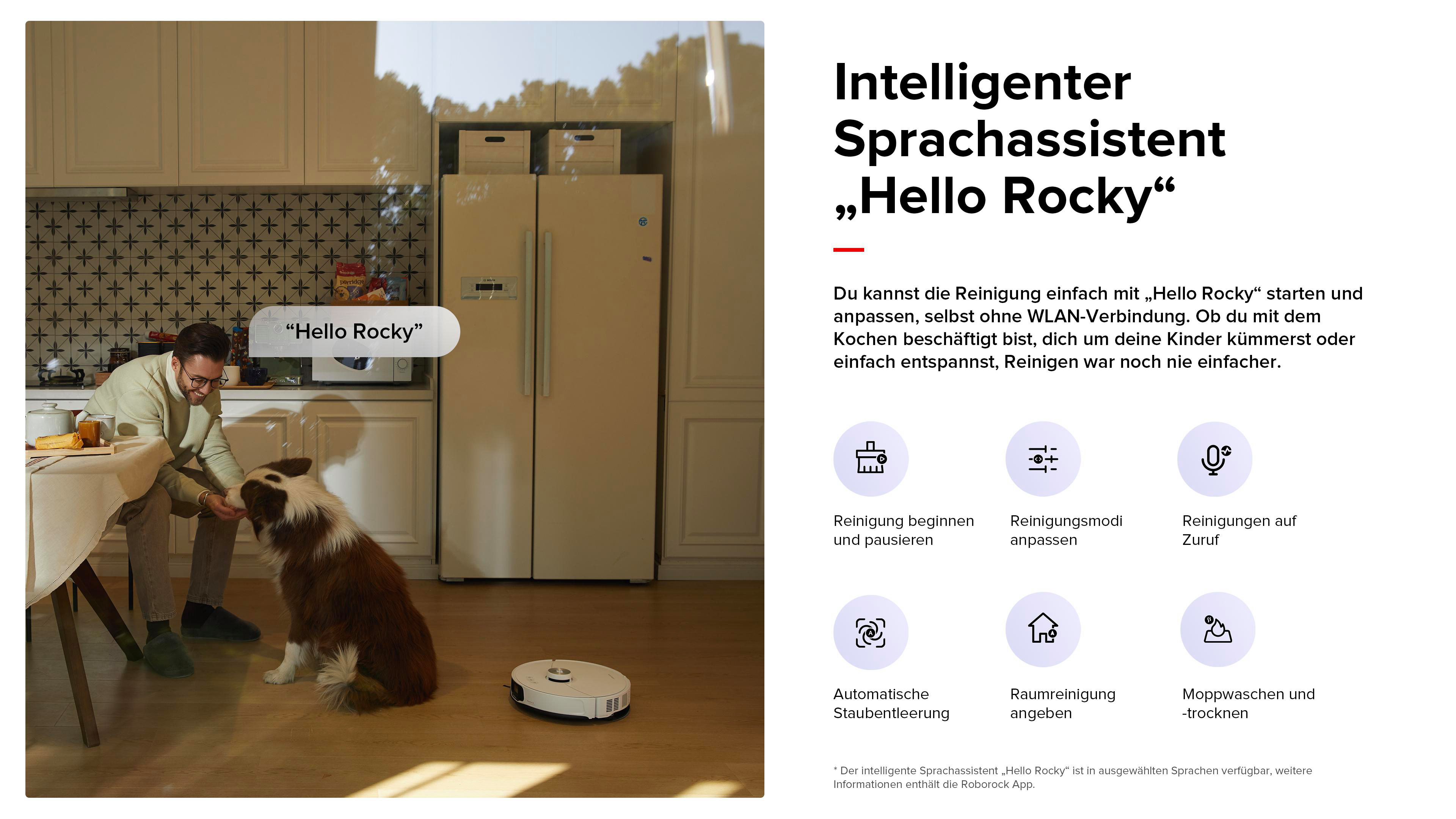 Ein Mann gibt einem Hund in einer Küche Futter. Ein Saugroboter steht auf dem Boden.