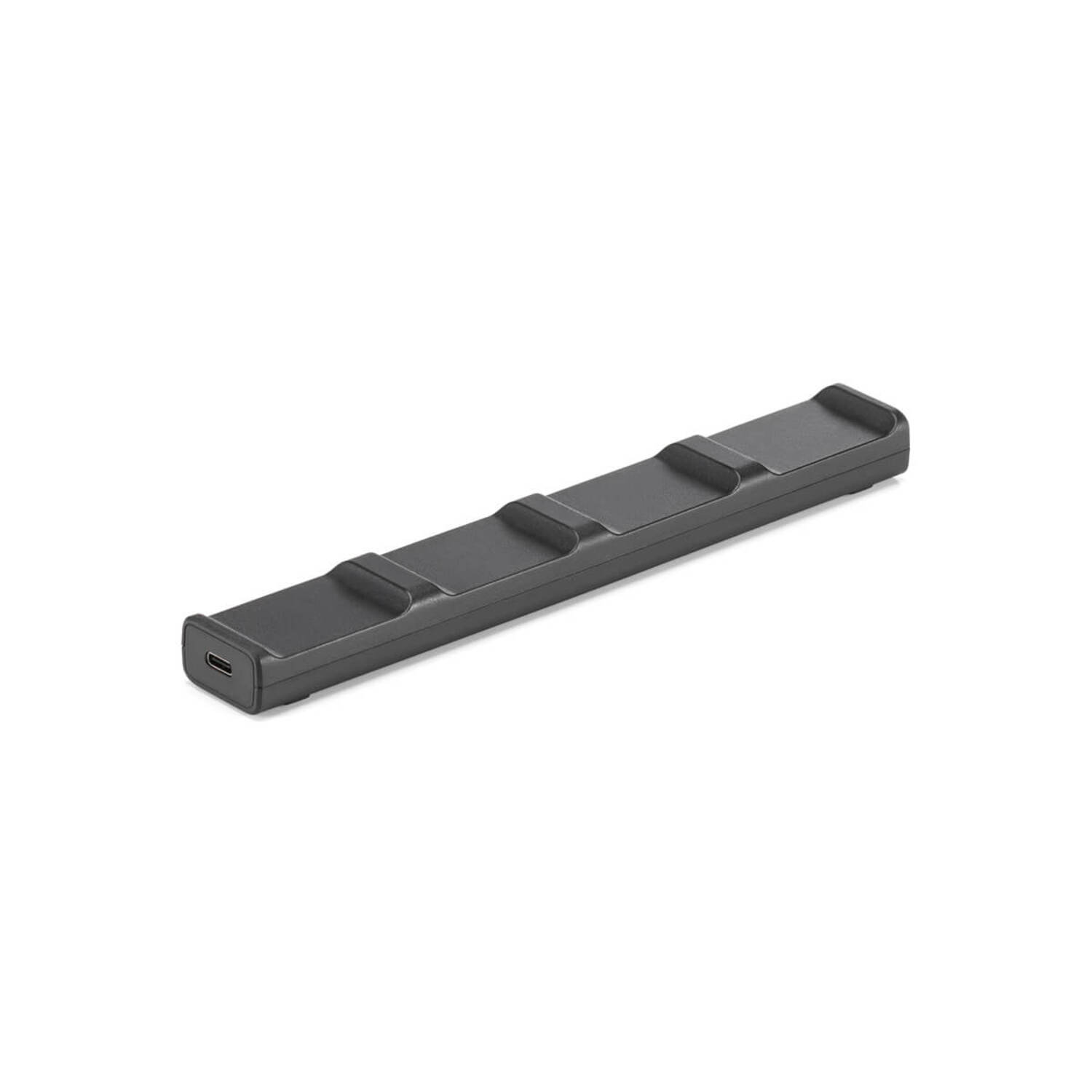 Black charging device with three raised sections and a USB port.