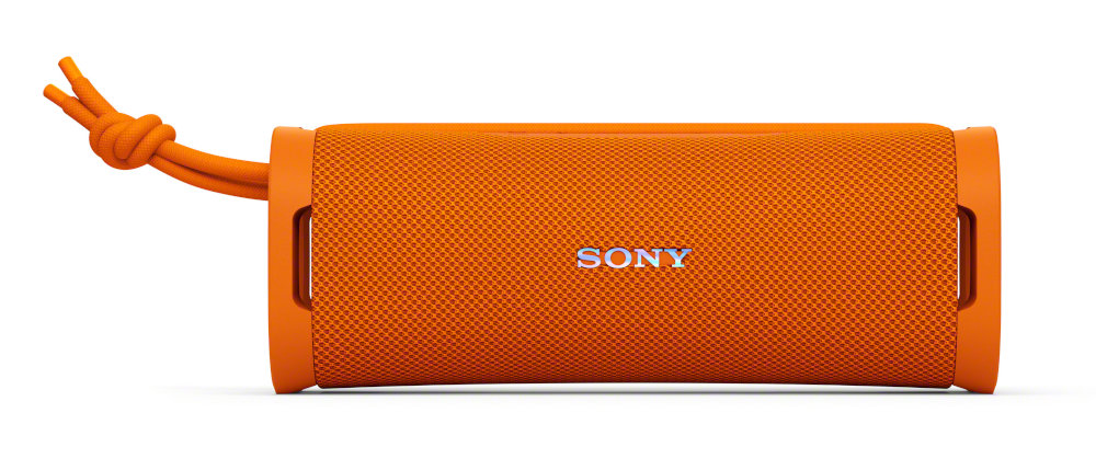 Pomarańczowy prostokątny głośnik z napisem SONY i pomarańczowym sznurkiem z boku.