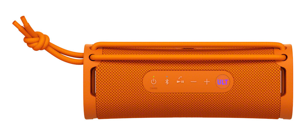 Pomarańczowy głośnik przenośny. Ma przyciski i sznurek do zawieszania.