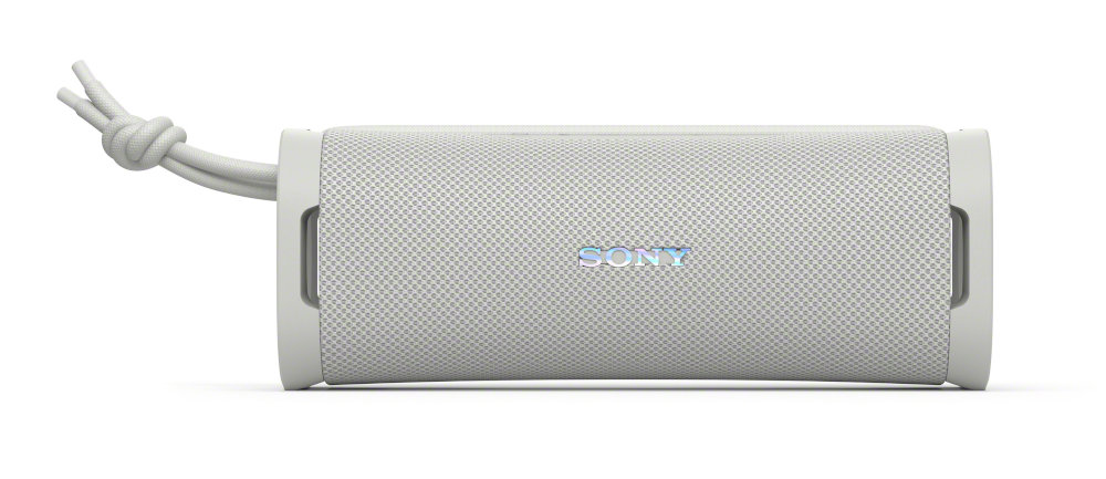 Biały głośnik Bluetooth Sony. Biały uchwyt z liny. Widoczne logo SONY.
