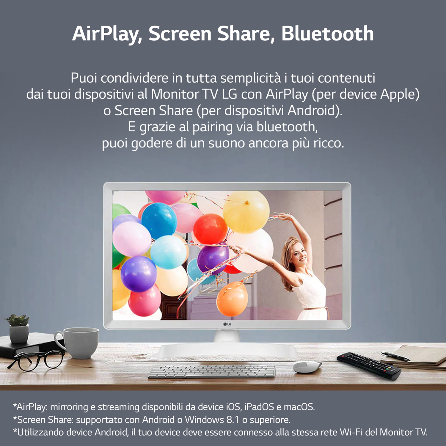 Un televisore bianco con uno schermo che mostra palloncini colorati, una donna e una tastiera.