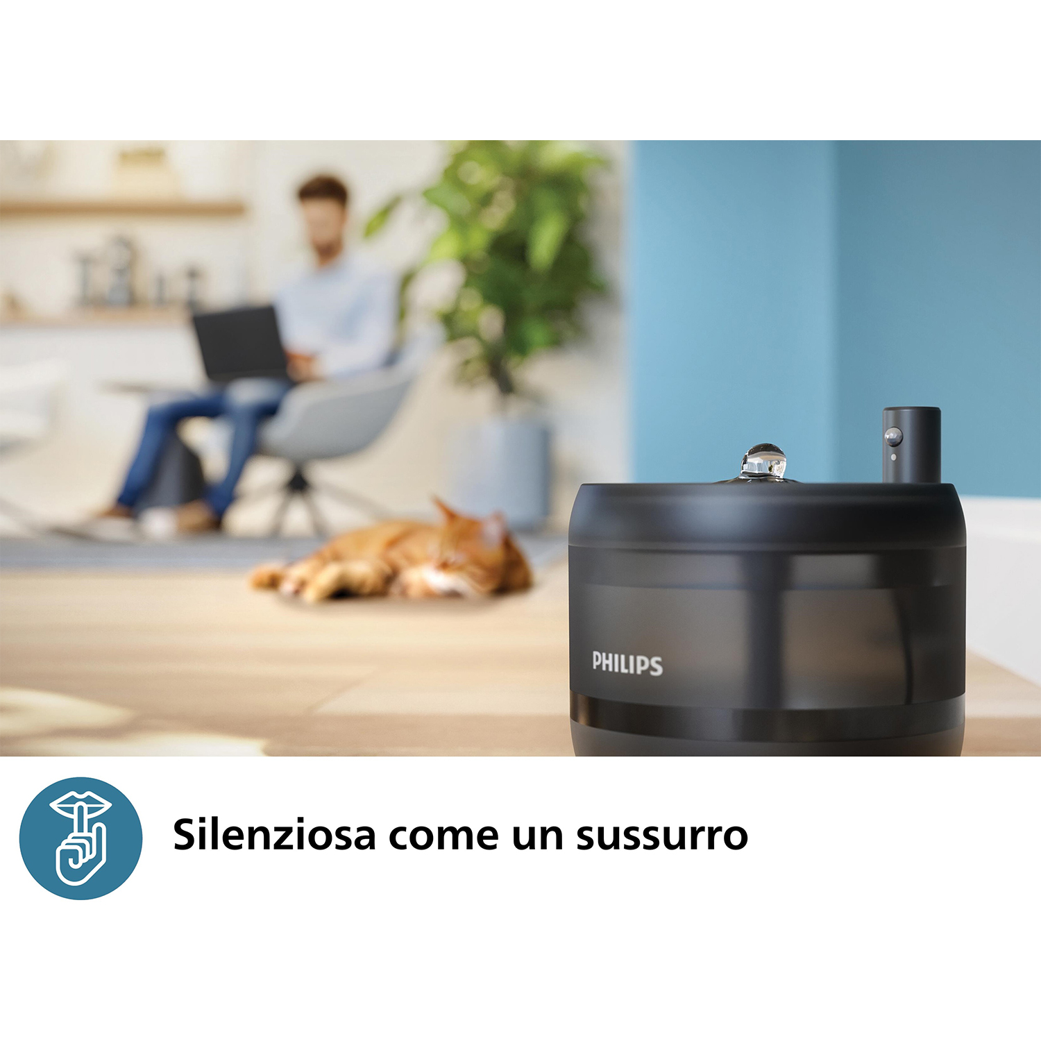 Umidificatore Philips nero su un tavolo, gatto e persona sullo sfondo, testo: Silenziosa.