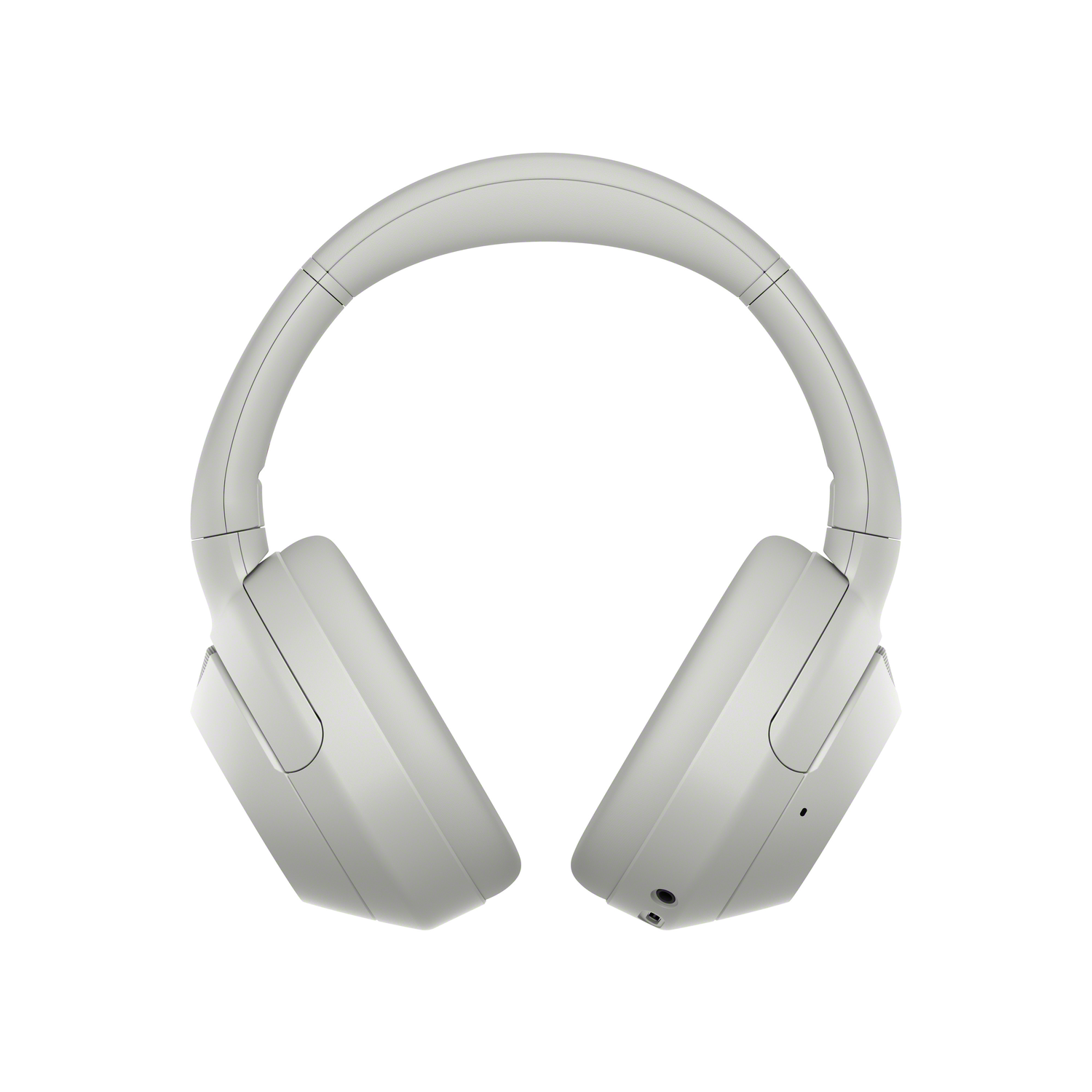 White headphones, seen from above, with a curved headband and two earcups.