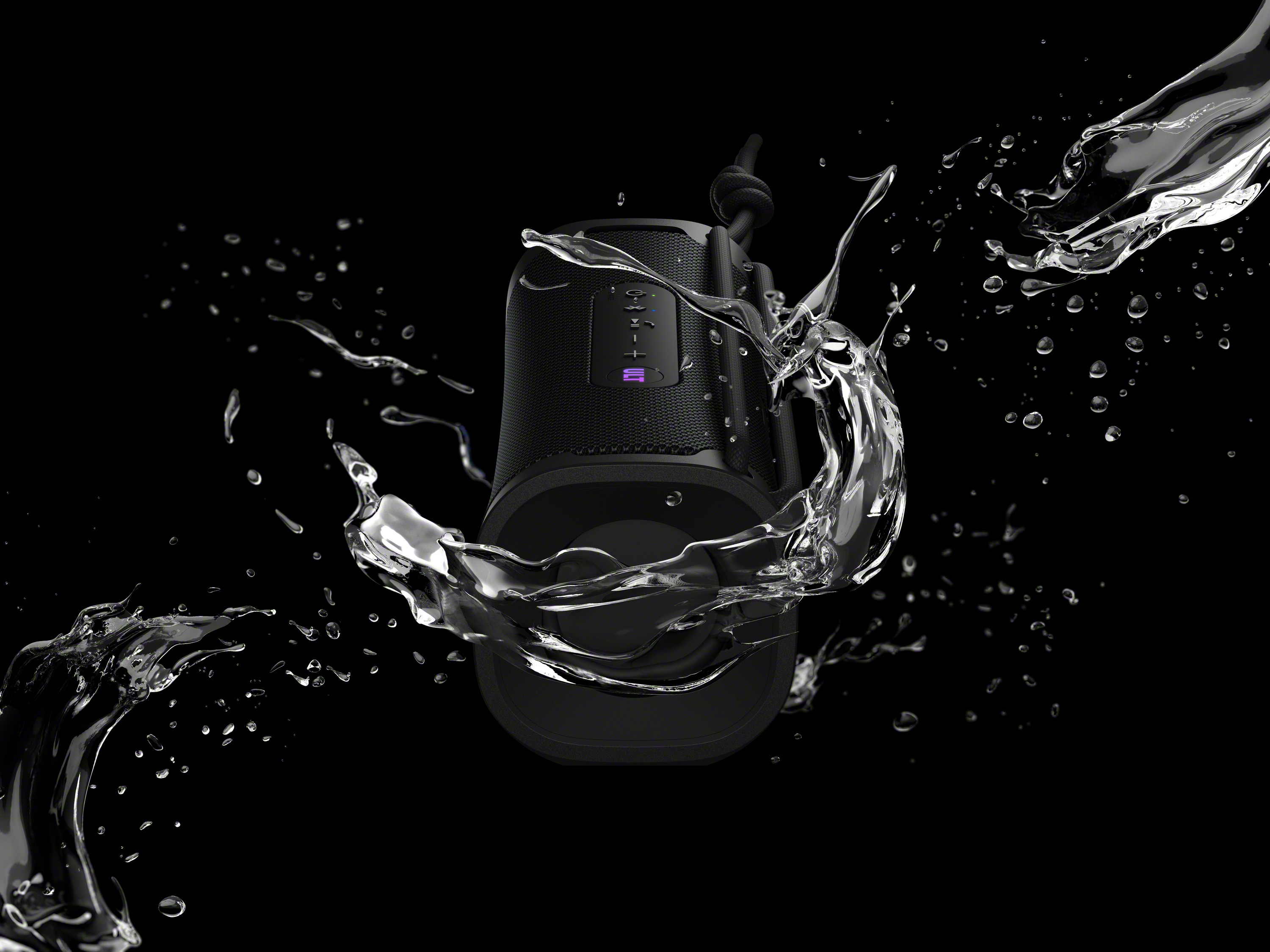 Altavoz Sony negro con salpicaduras de agua sobre un fondo negro.
