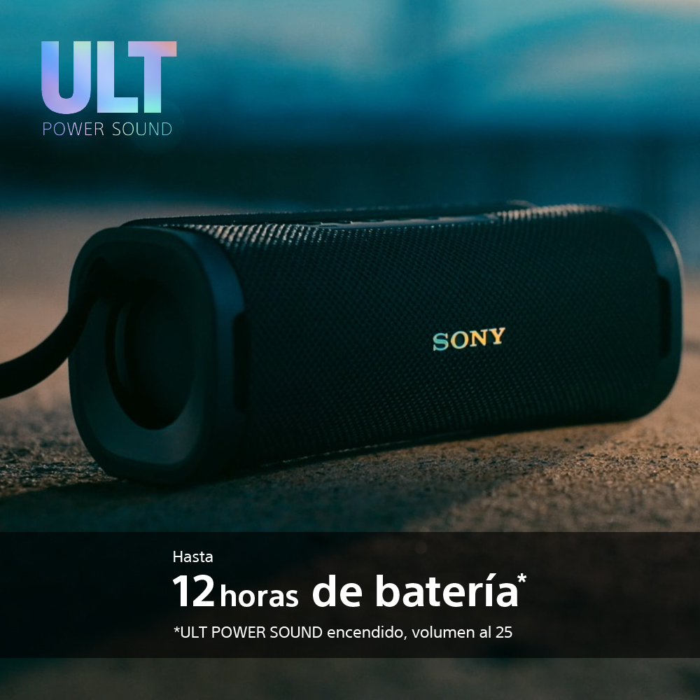 Un altavoz portátil negro con el texto que dice, "12 horas de batería". Luces en el fondo.