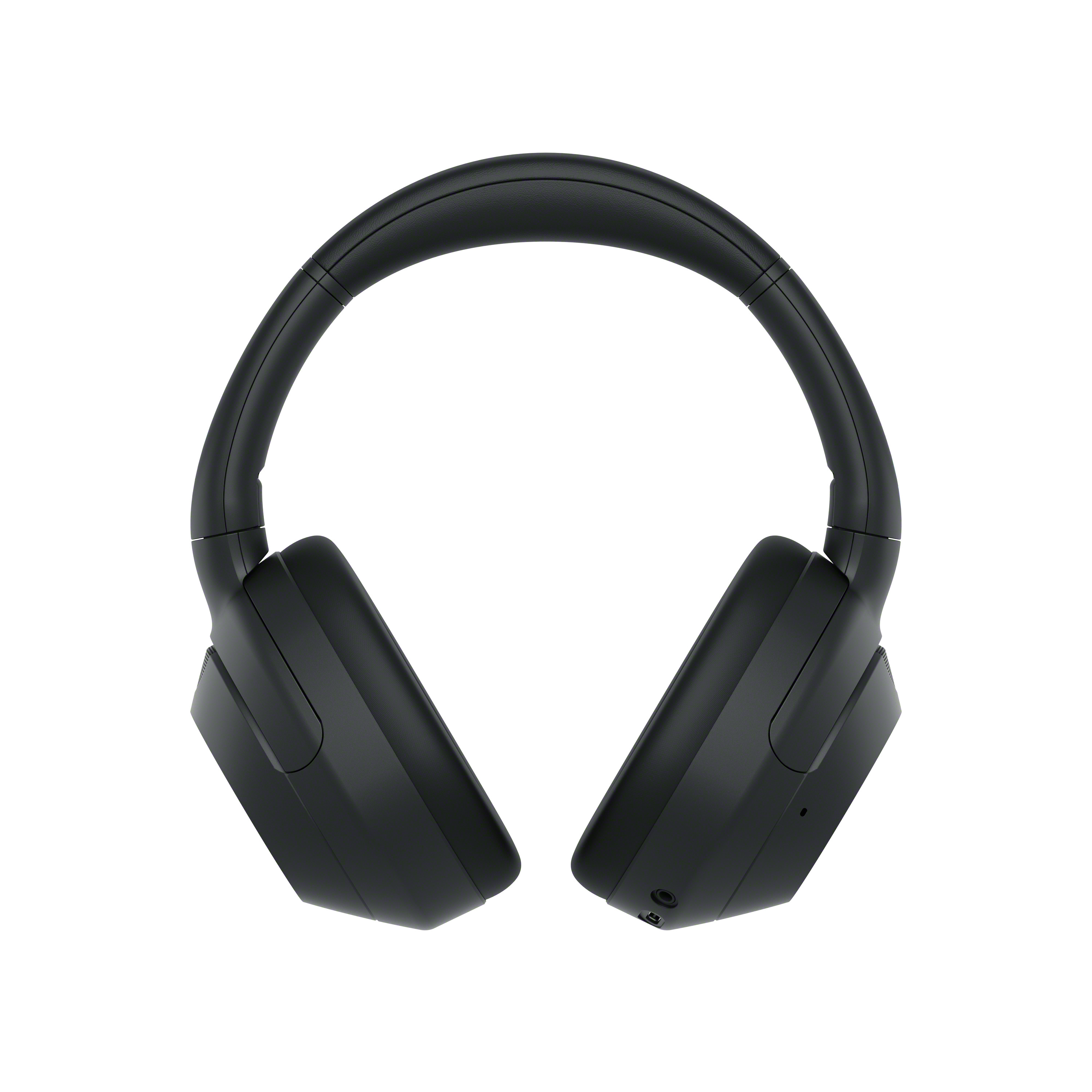Auriculares negros sobre un fondo blanco. Los auriculares tienen un diseño redondeado y son circumaurales.