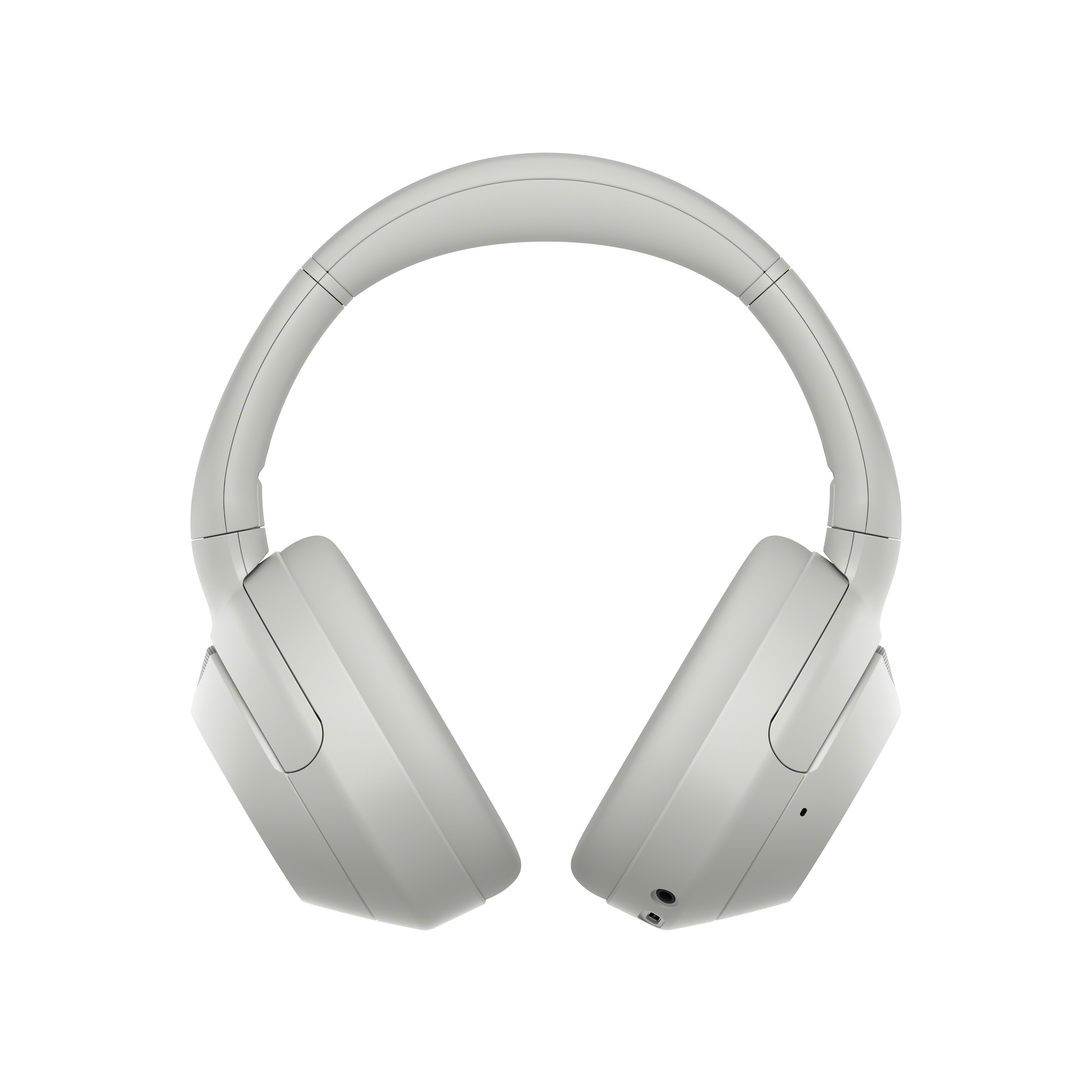 Auriculares grises sobre un fondo blanco. Son de estilo diadema.