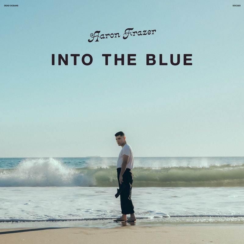 Mann am Strand mit Wellen im Hintergrund und Text 'Aaron Frazer INTO THE BLUE'.