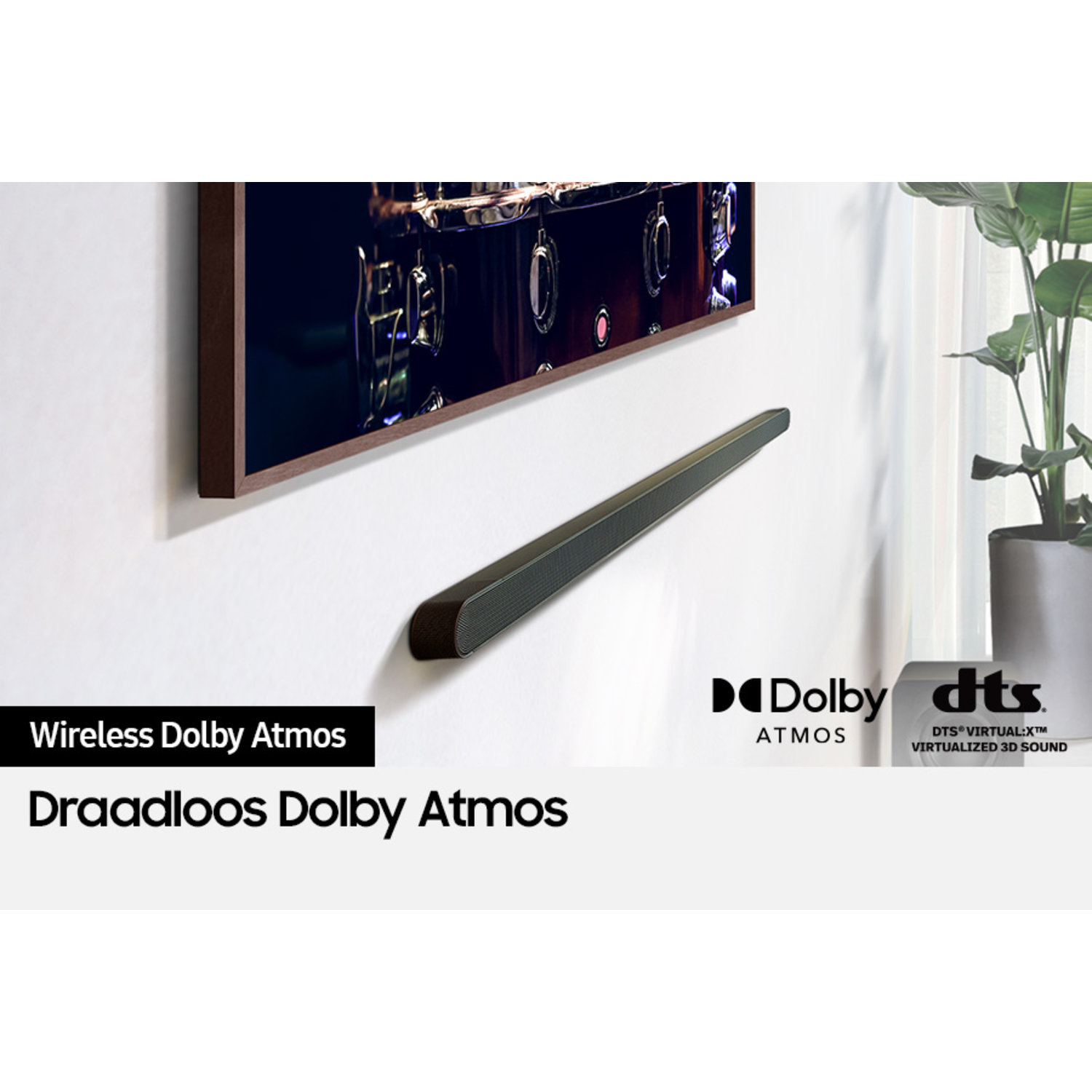Soundbar on white wall below TV. Dolby Atmos and DTS logos are visible.