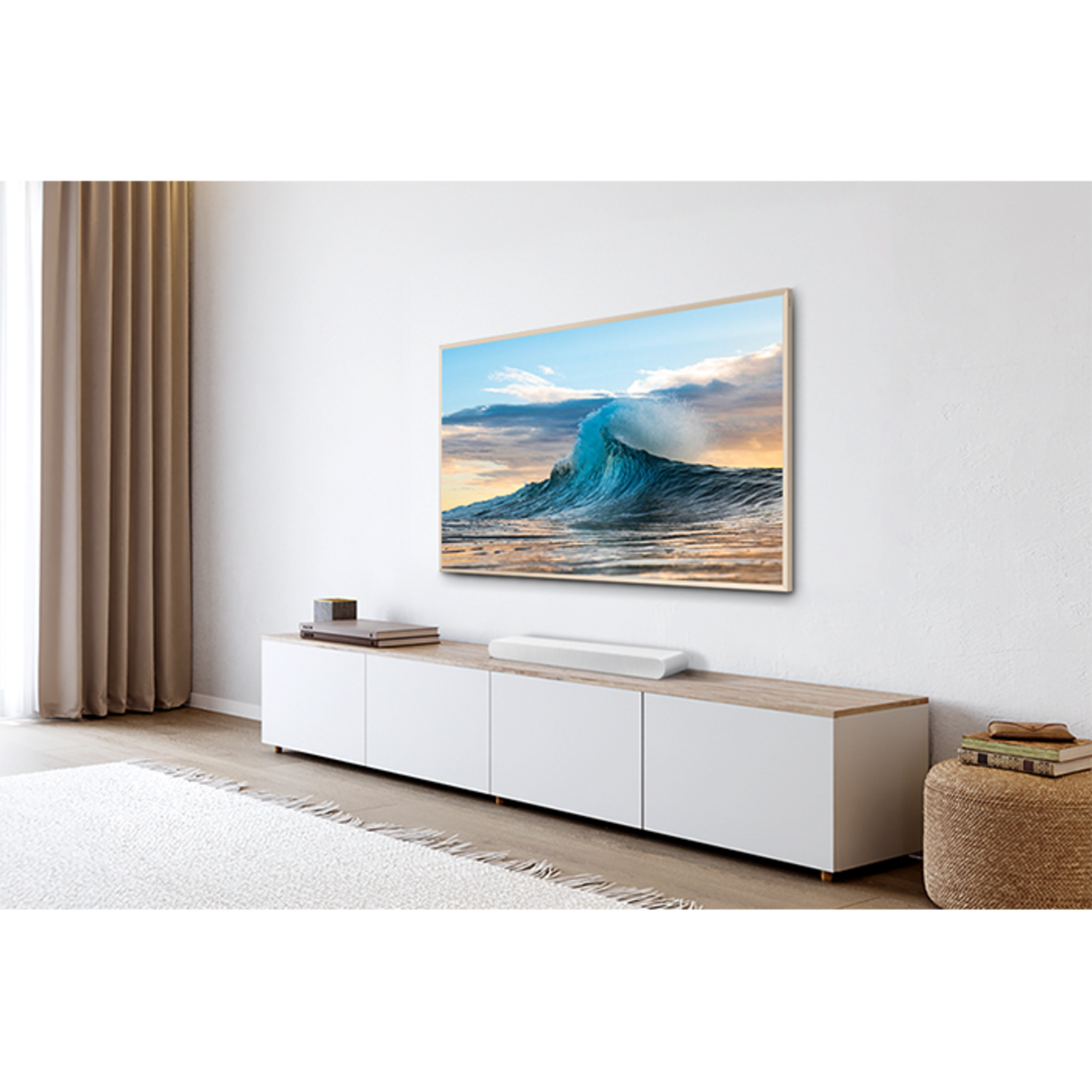 Living room with a TV showing a wave. White cabinet, rug, and beige curtains.