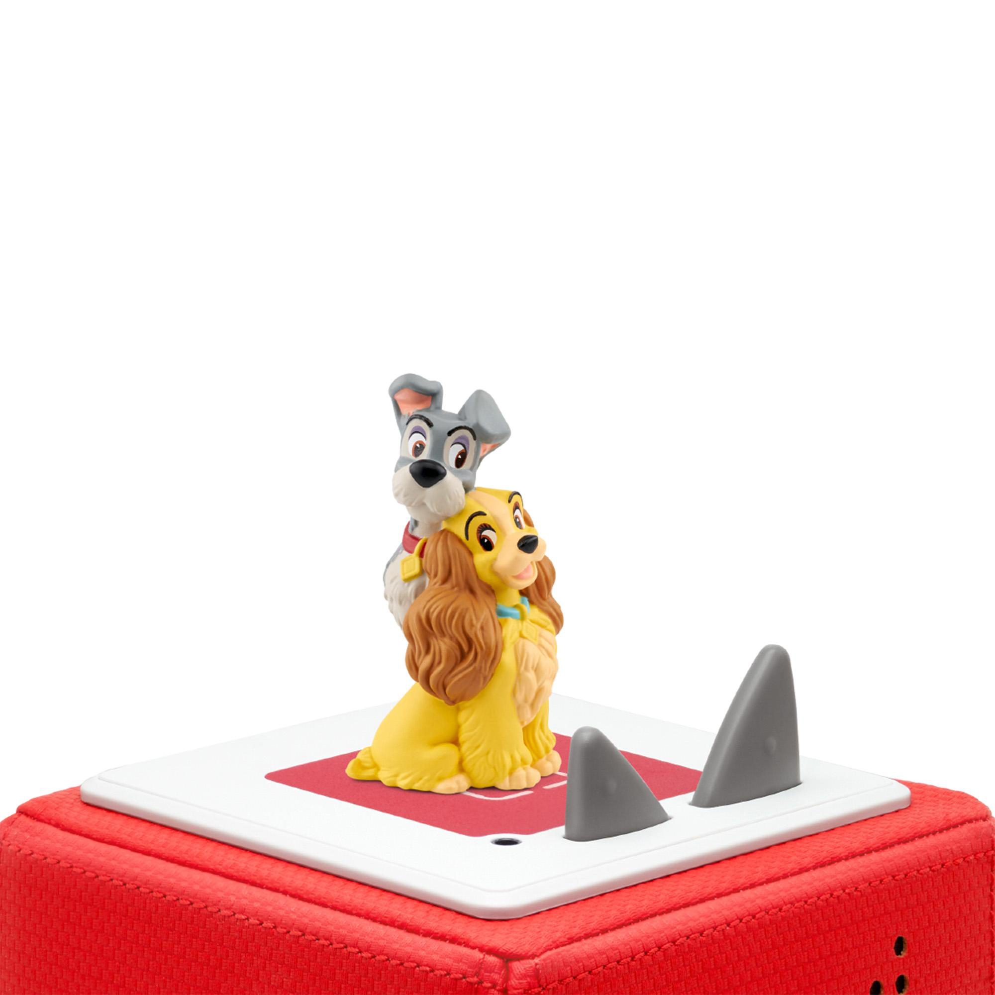 Eine Lady-und-Tramp-Figur auf roter Basis. Tramp ist hinter Lady. Zwei graue Haifischflossen-Dekorationen.