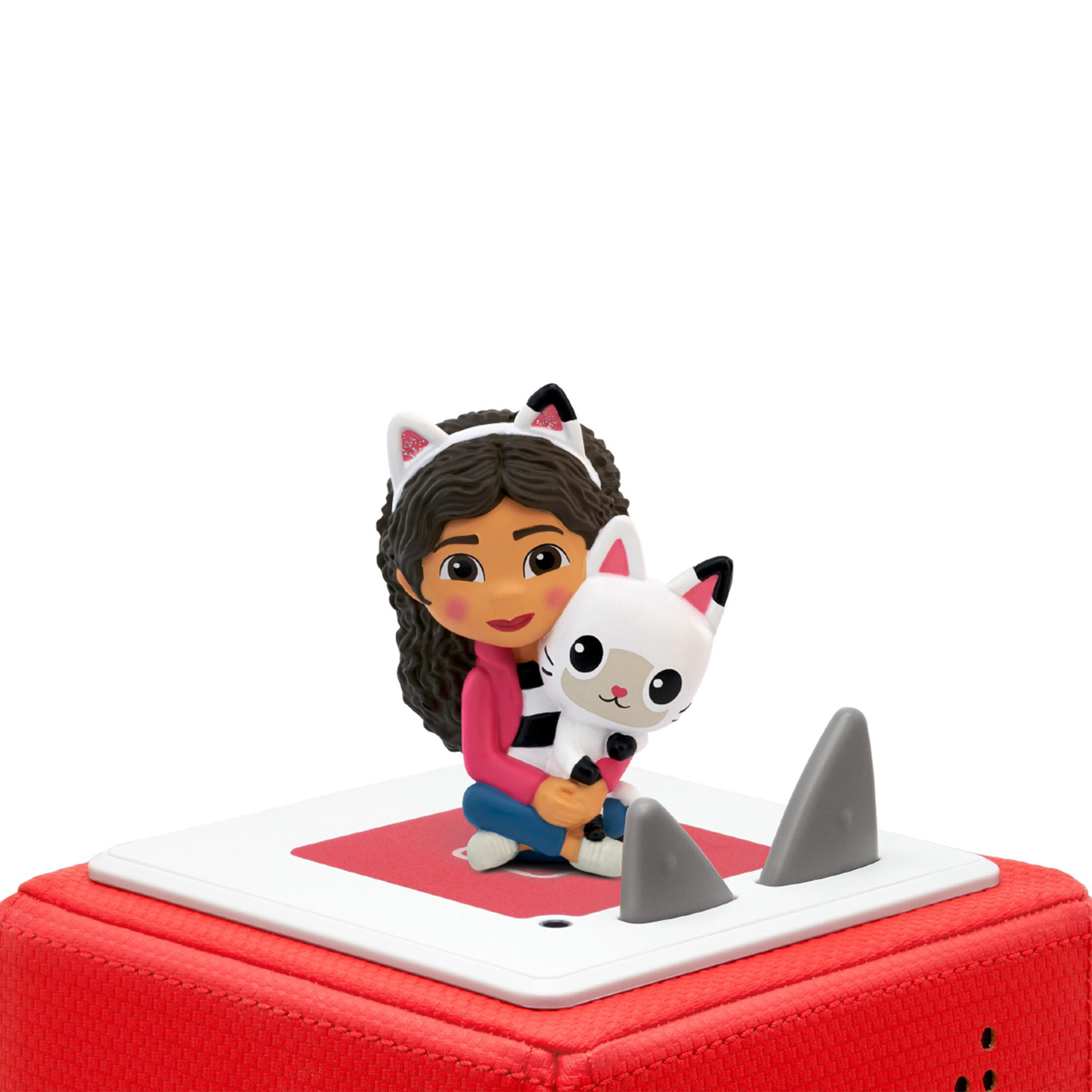 Eine Spielfigur eines Mädchens, das eine Katze hält, auf einer roten Basis mit Haifischflossen.