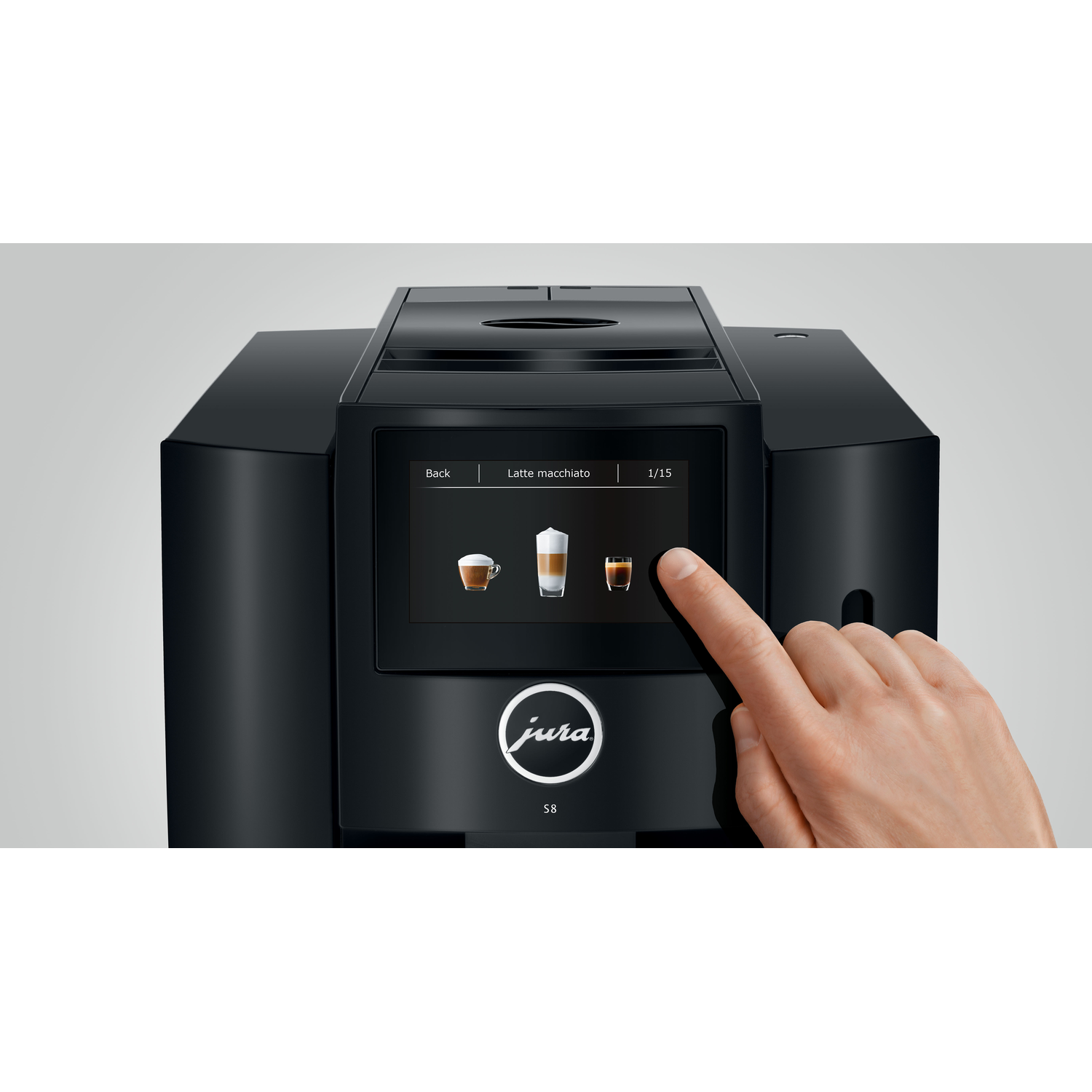 A black Jura S8 coffee machine with a touchscreen, a hand is touching the screen.
