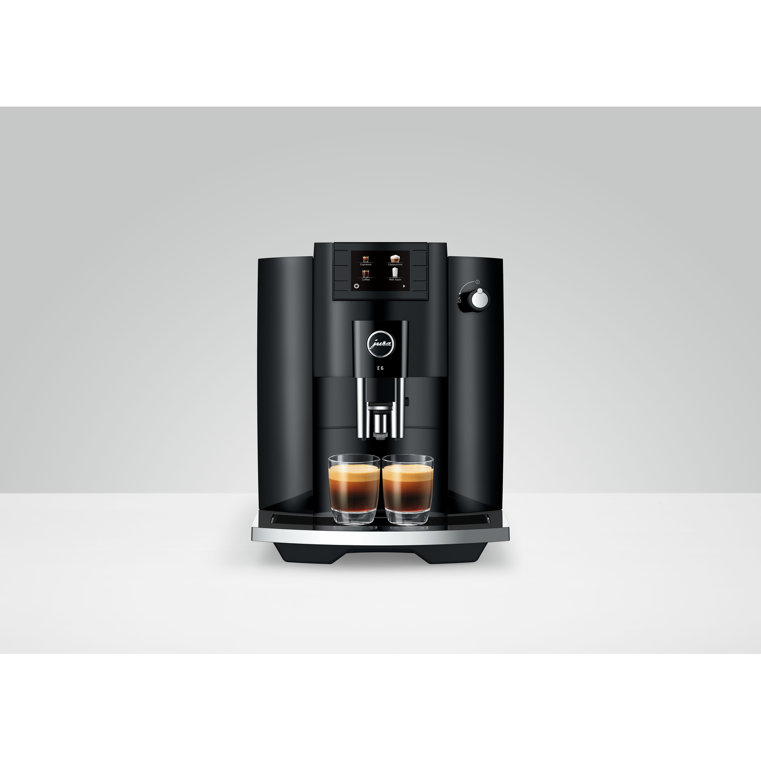 A black Jura coffee machine with two glasses of coffee on a white surface.