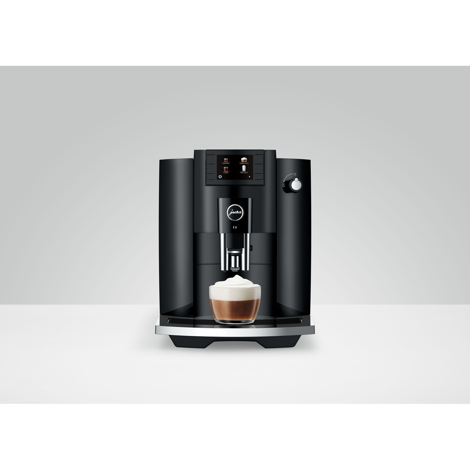 Black coffee machine with a cup of coffee in front, white background.