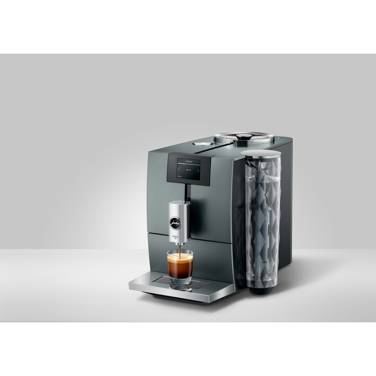 Coffee machine with a cup of coffee being poured, on a light gray surface.