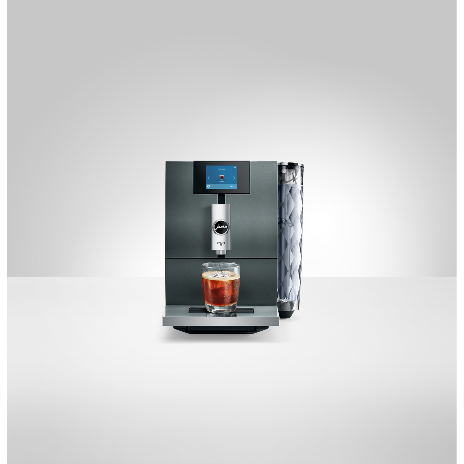 A gray coffee machine with a glass of coffee.