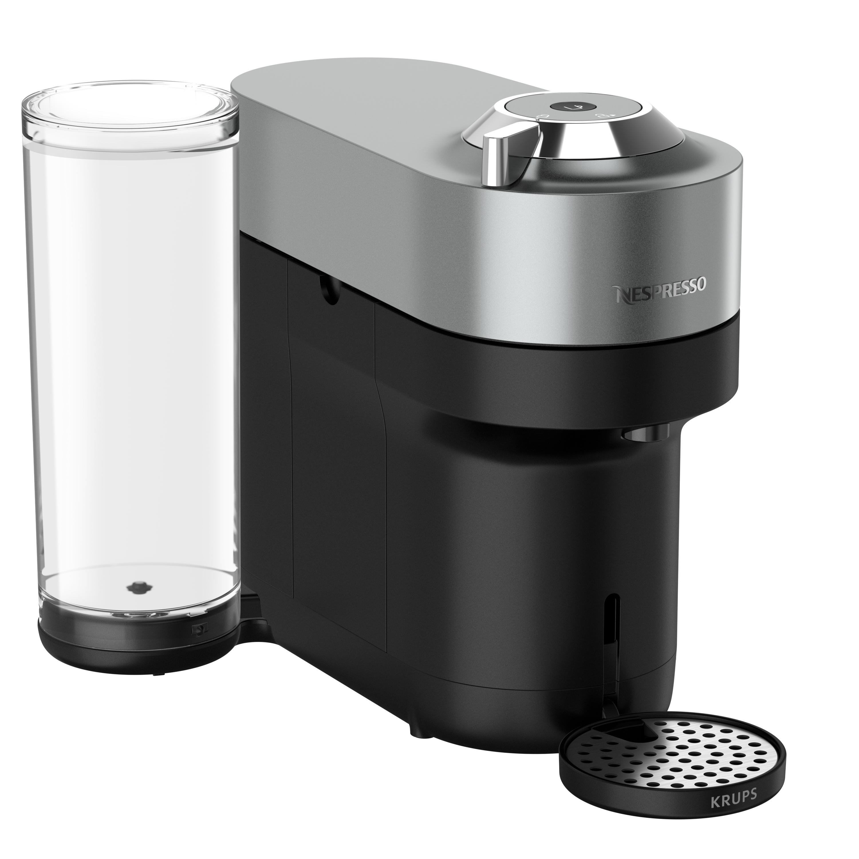 Eine Nespresso-Kaffeemaschine, silberner Deckel, schwarzer Sockel, mit Glastank.