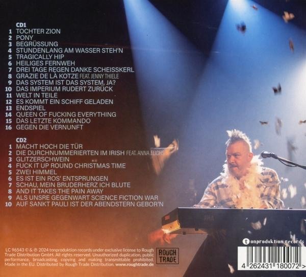 Albumcover mit einem Mann, der Keyboard spielt. Texte links und Bühnenhintergrund.