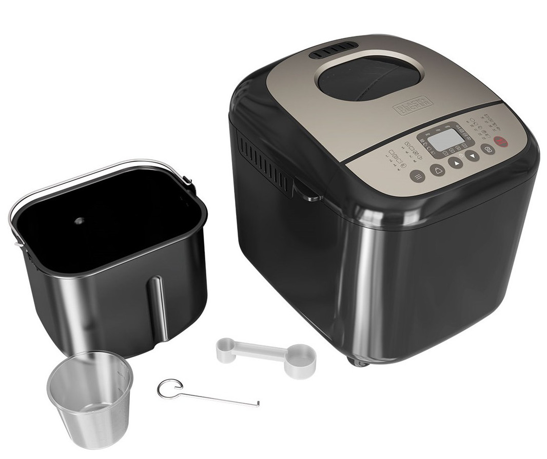 Czarna maszyna do pieczenia chleba z otwartą patelnią do chleba i innymi akcesoriami.