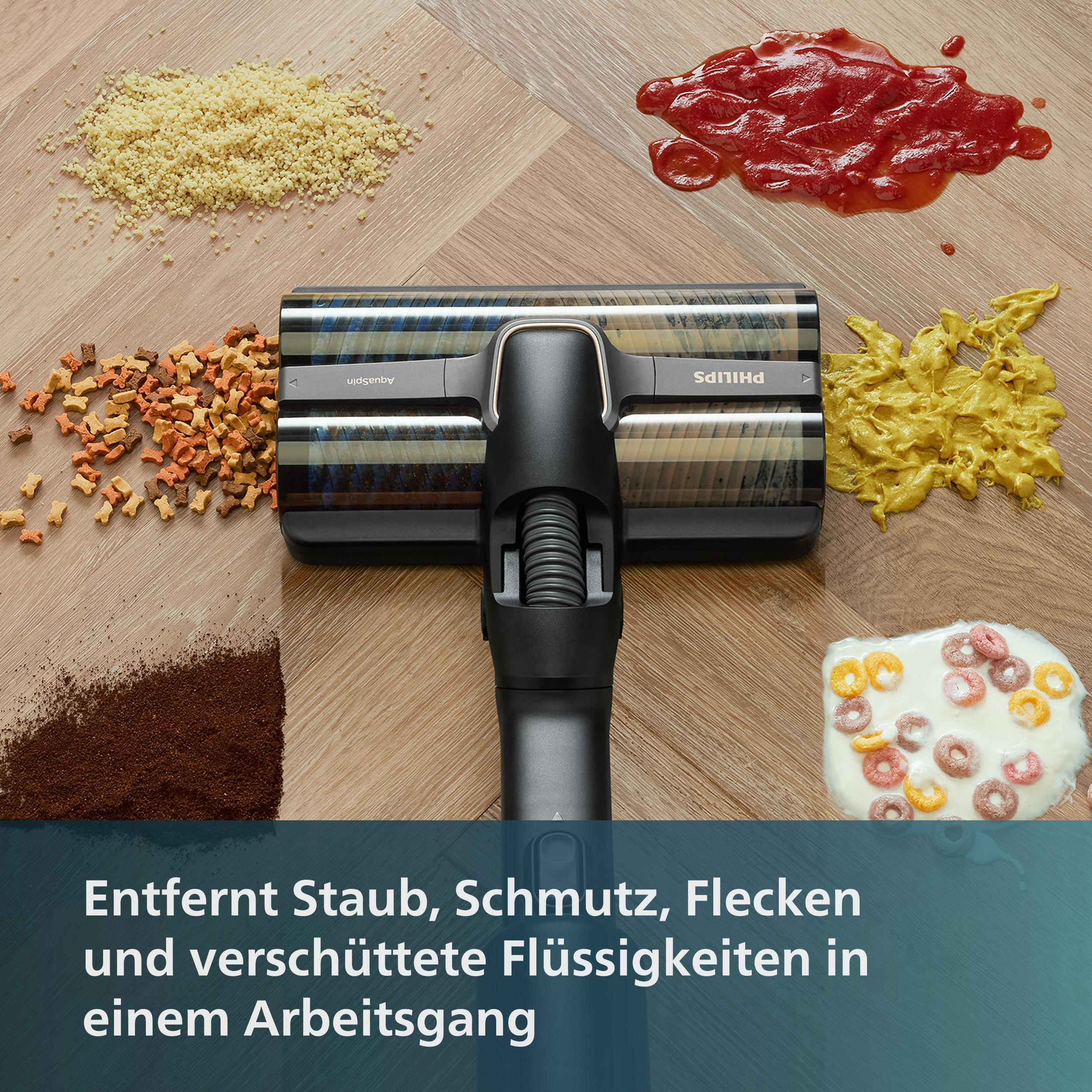 Ein Staubsaugerkopf, umgeben von verschütteten Lebensmitteln und Ablagerungen auf einem Holzboden.