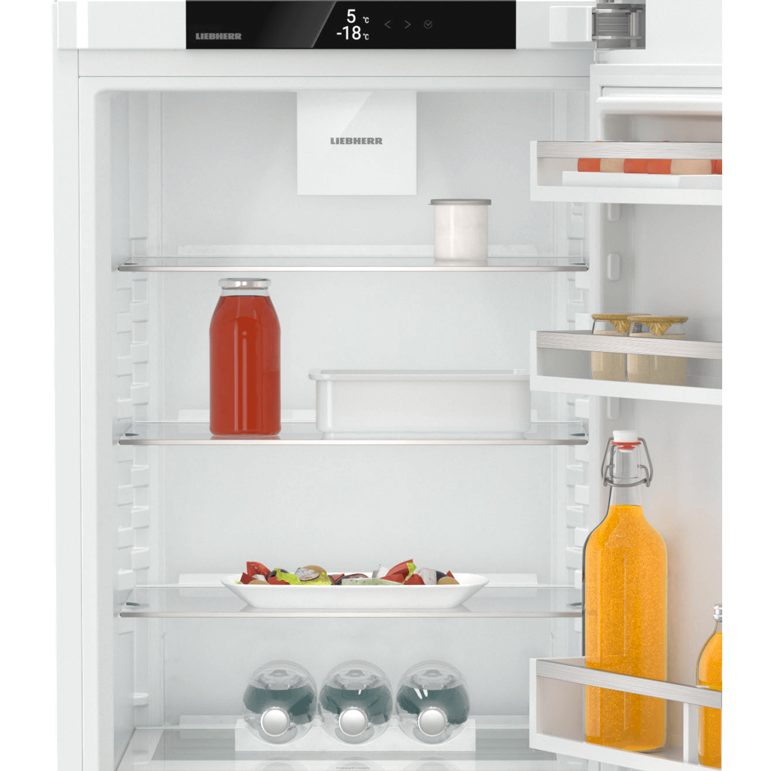 Refrigerator interior with shelves, containing food items and drinks, with a display.