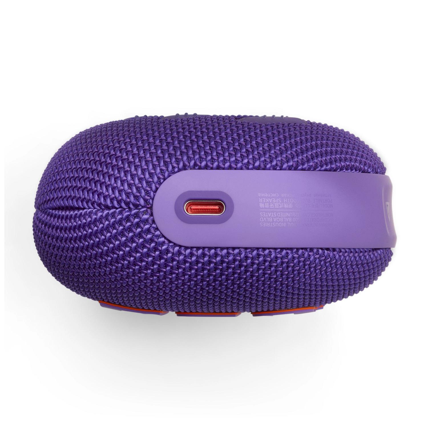 Enceinte portable JBL violette avec housse en tissu, port de charge et touches orange.