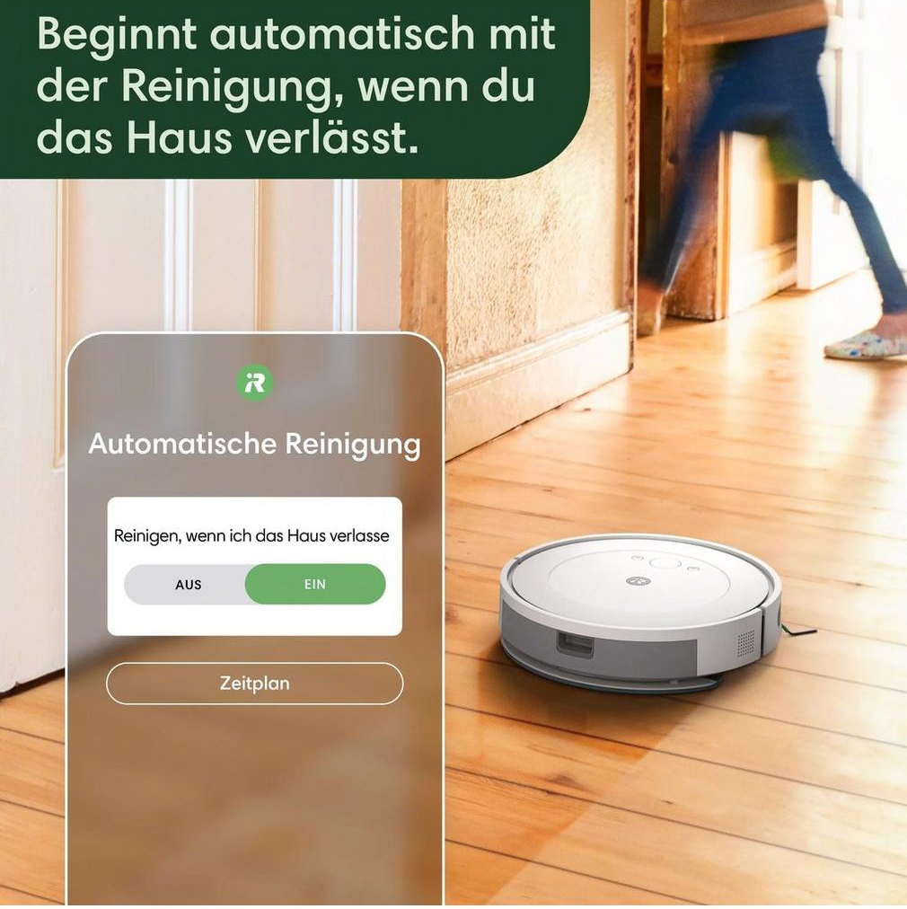 Ein Roboter-Staubsauger auf Holzboden, mit einem Telefon, das eine App zeigt.