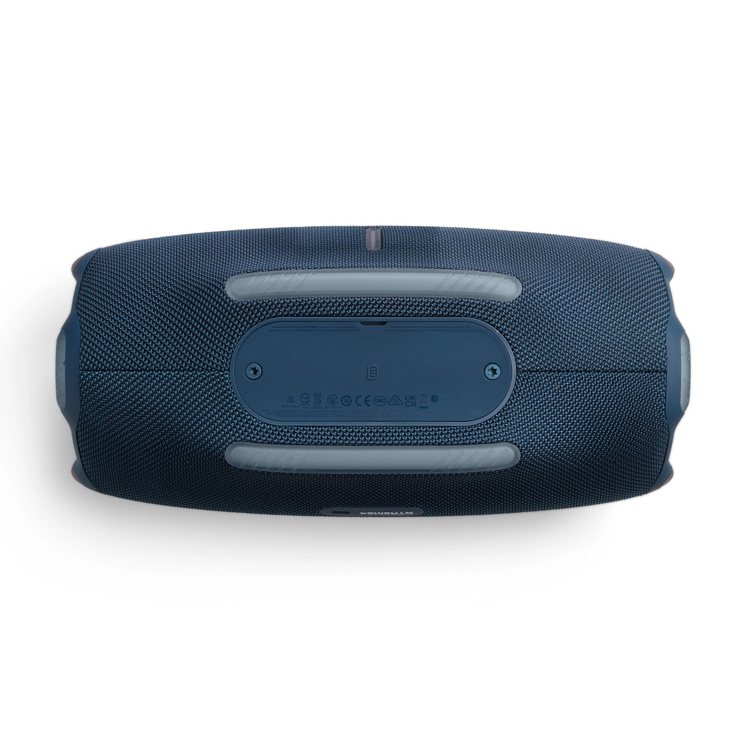 Le dessous d'une enceinte JBL recouverte de tissu bleu avec des accents gris.