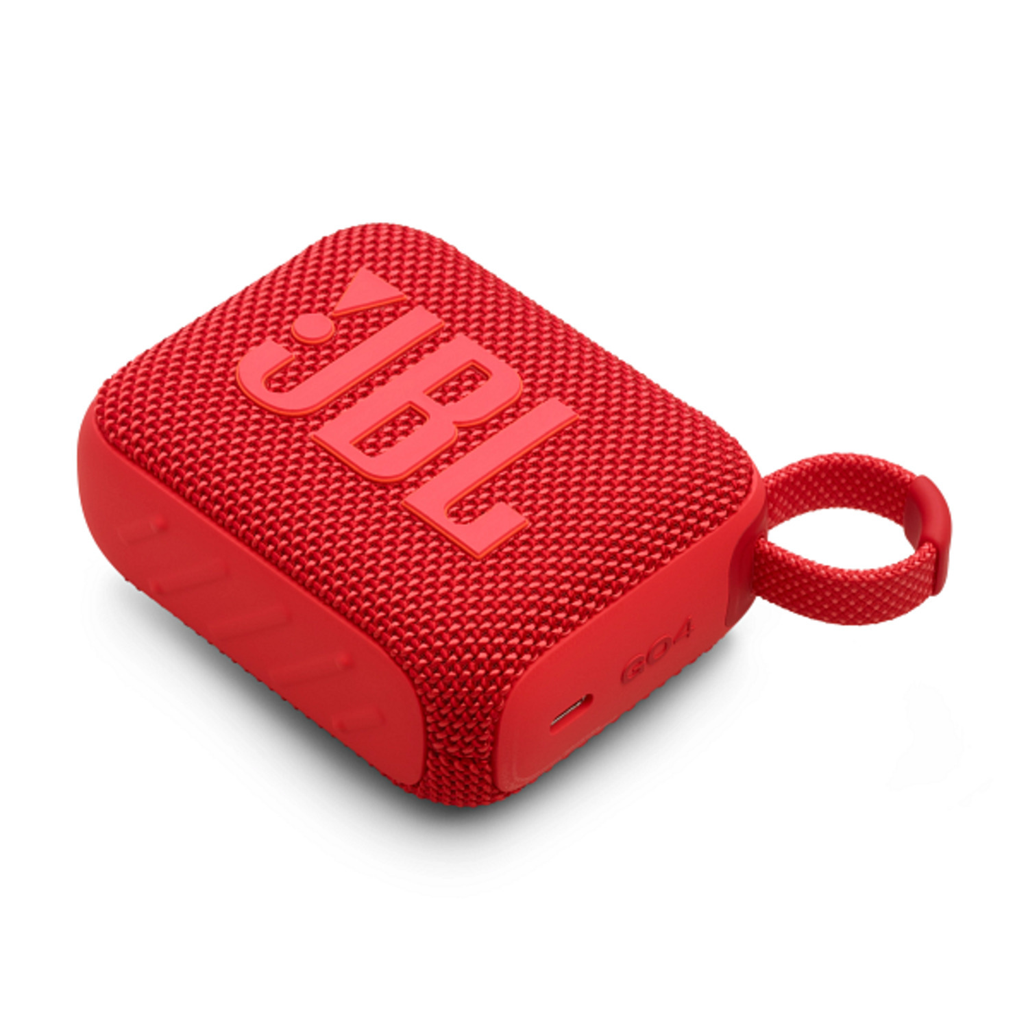 Red JBL Go 4 speaker on a white surface. The speaker has the JBL logo.