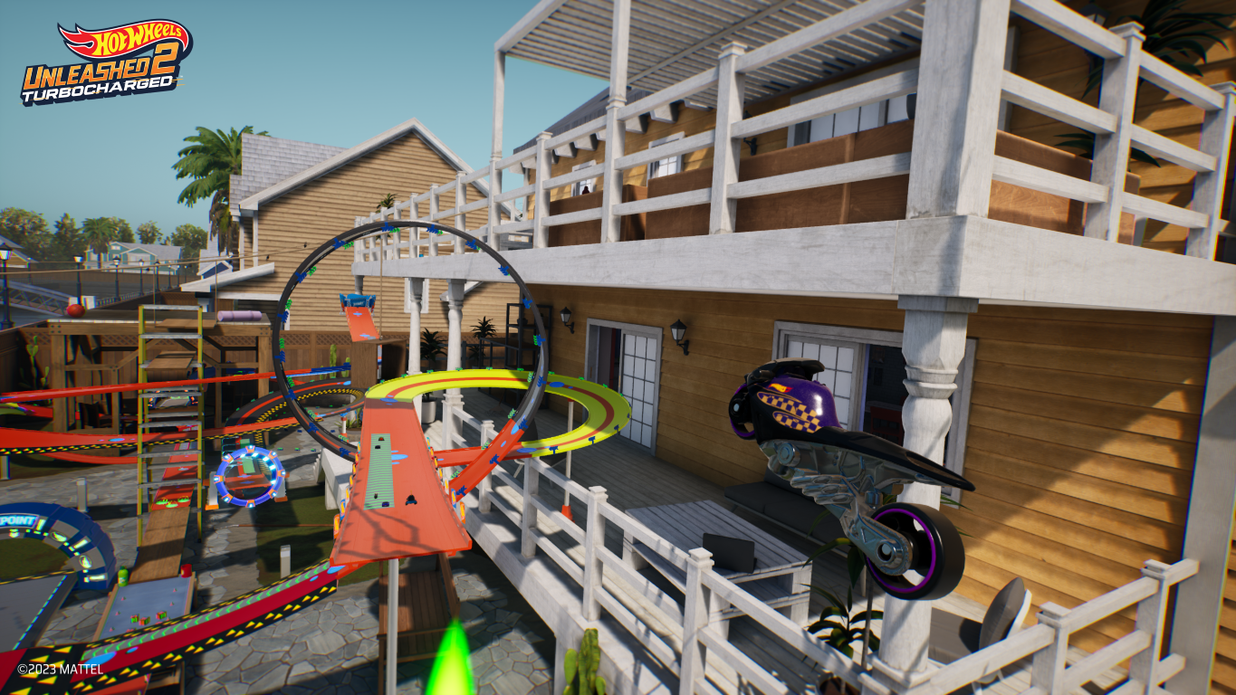 Scena z gry wideo z torem i budynkami. Pojazd jest w powietrzu po prawej stronie.