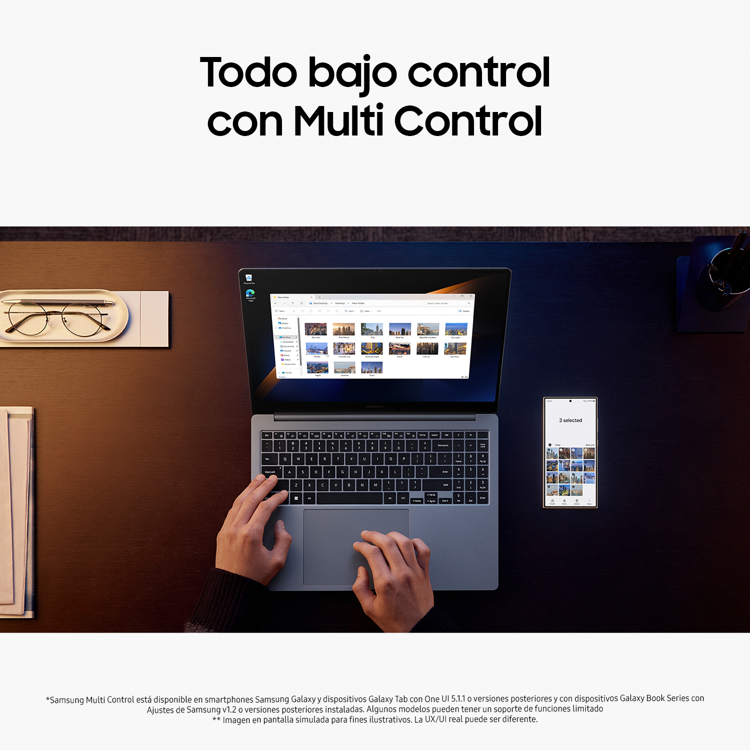 Un portátil con pantalla, manos usando el teclado y un teléfono.