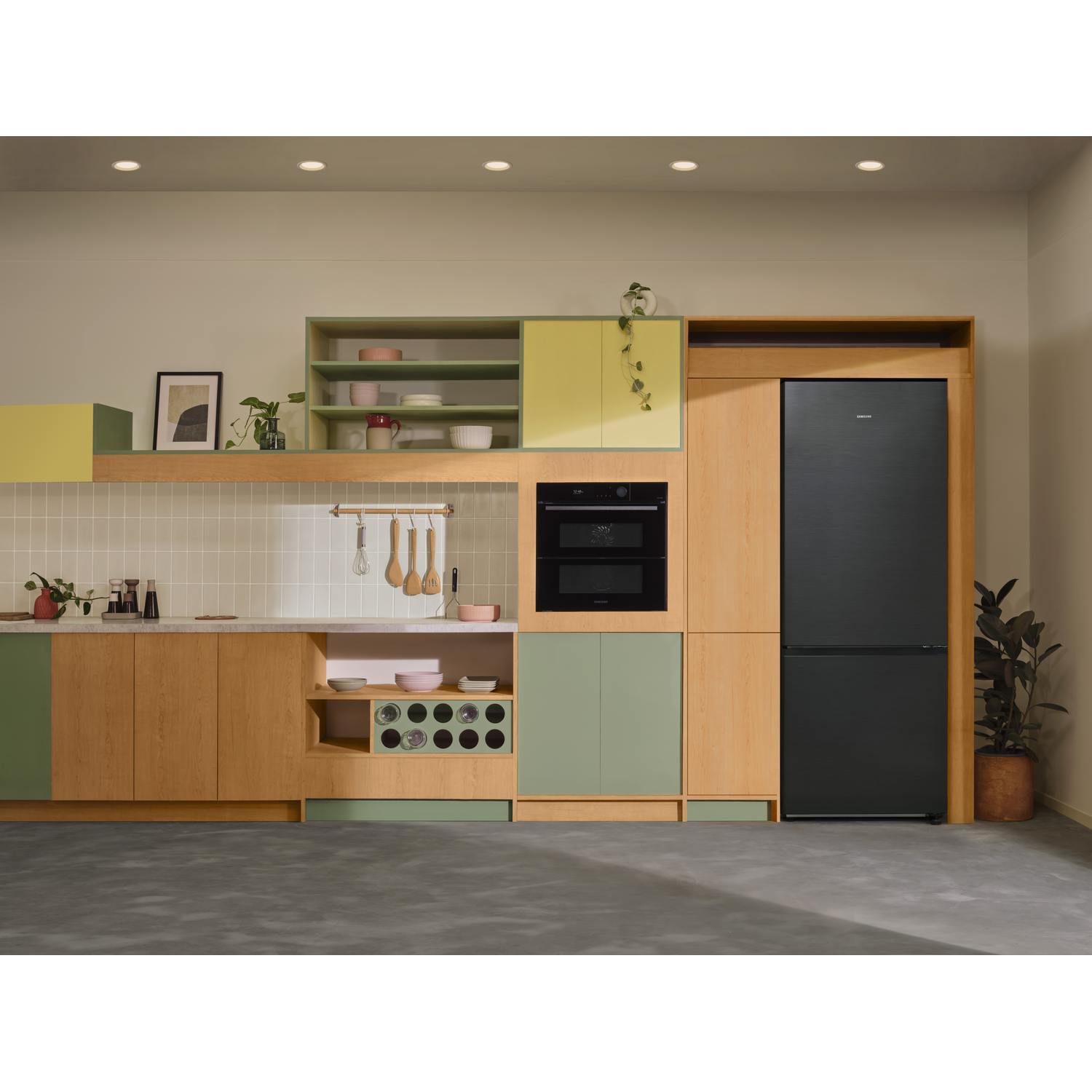 A modern kitchen with wooden and green cabinets, a black fridge, and built-in appliances.