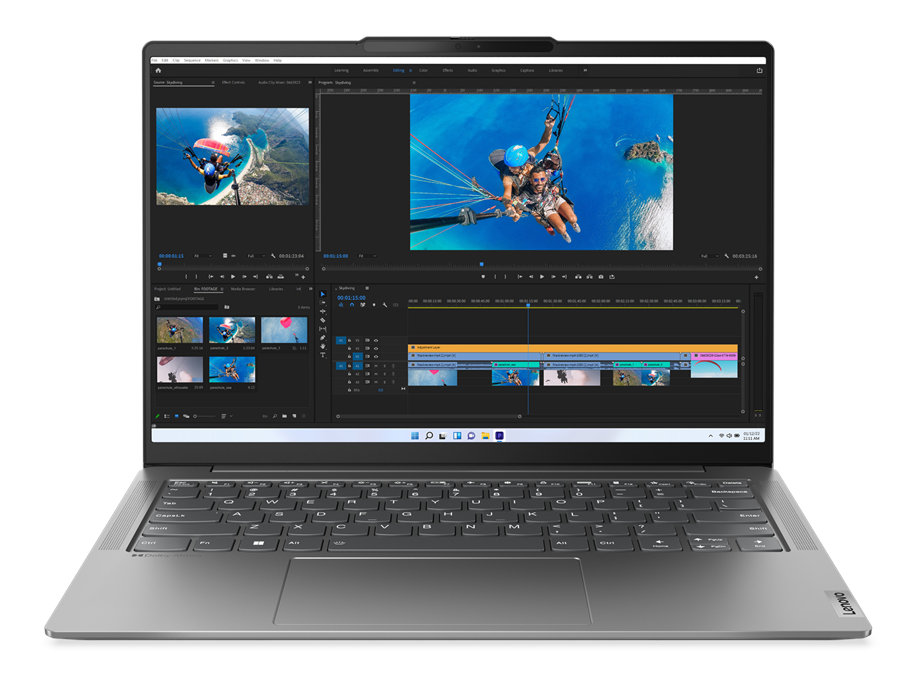 Laptop na białej powierzchni, wyświetlający oprogramowanie do edycji wideo. Ekran pokazuje klipy wideo i oś czasu.