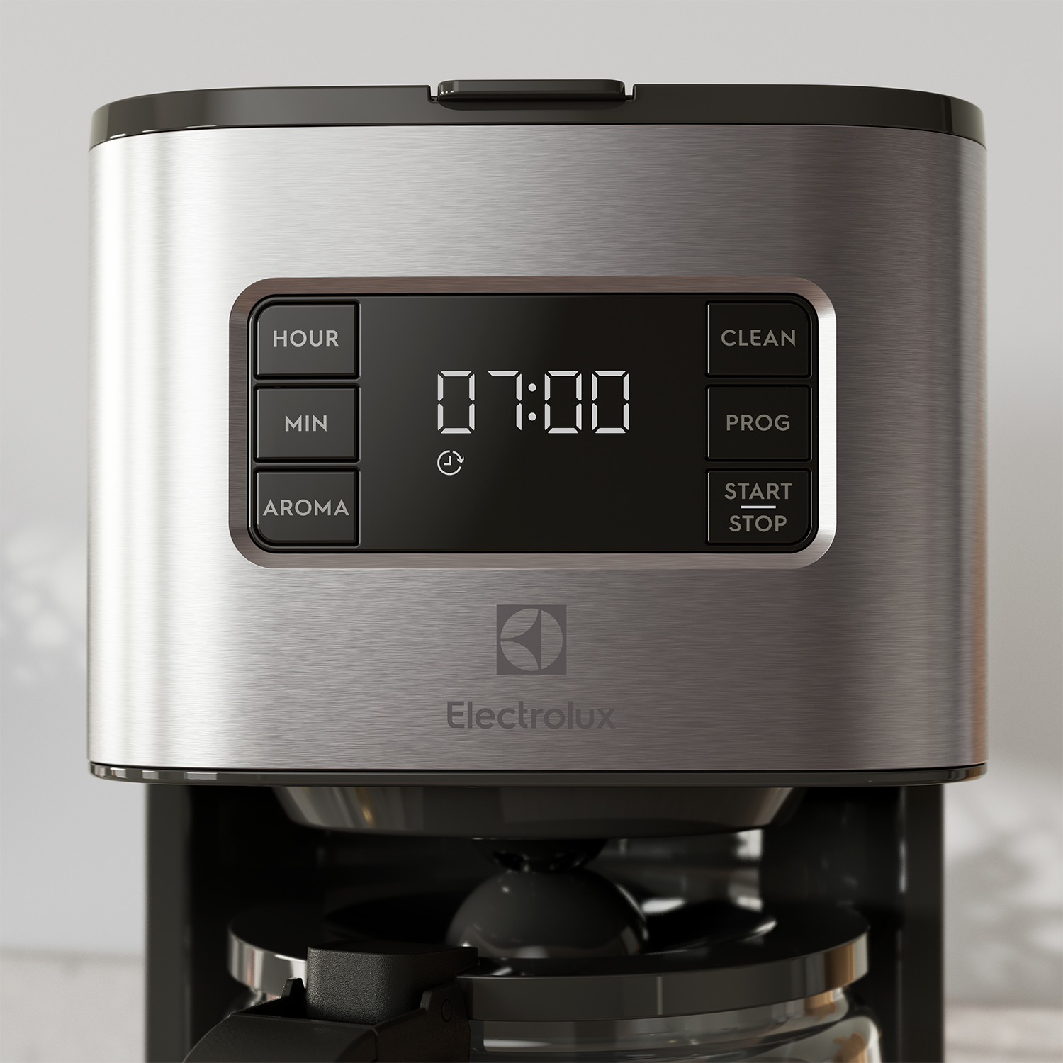 Primo piano di una macchina da caffè argentata con schermo LCD e pulsanti di controllo.