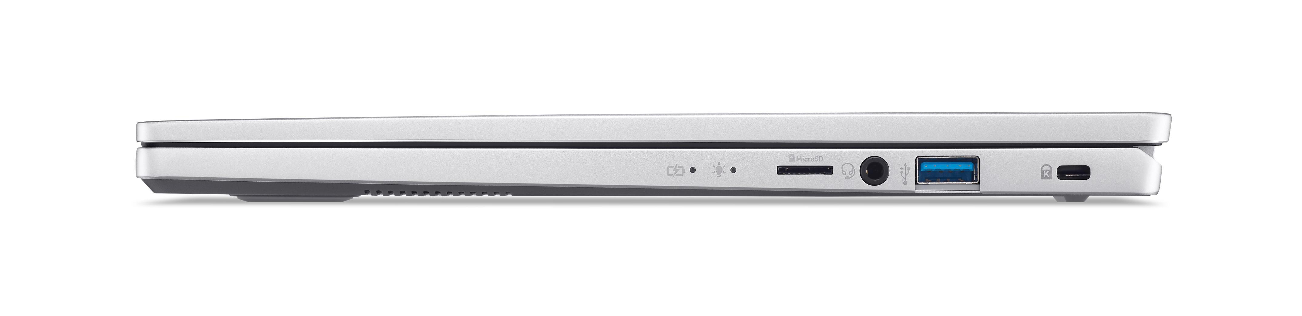 Seitenansicht eines weißen Laptops, mit Anschlüssen zum Aufladen, USB und anderen Verbindungen.