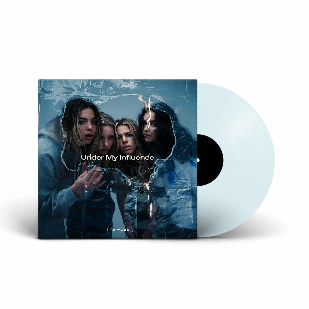 Album borító: négy nő átlátszó anyag előtt, 'Under My Influence' felirat és egy bakelit lemez.