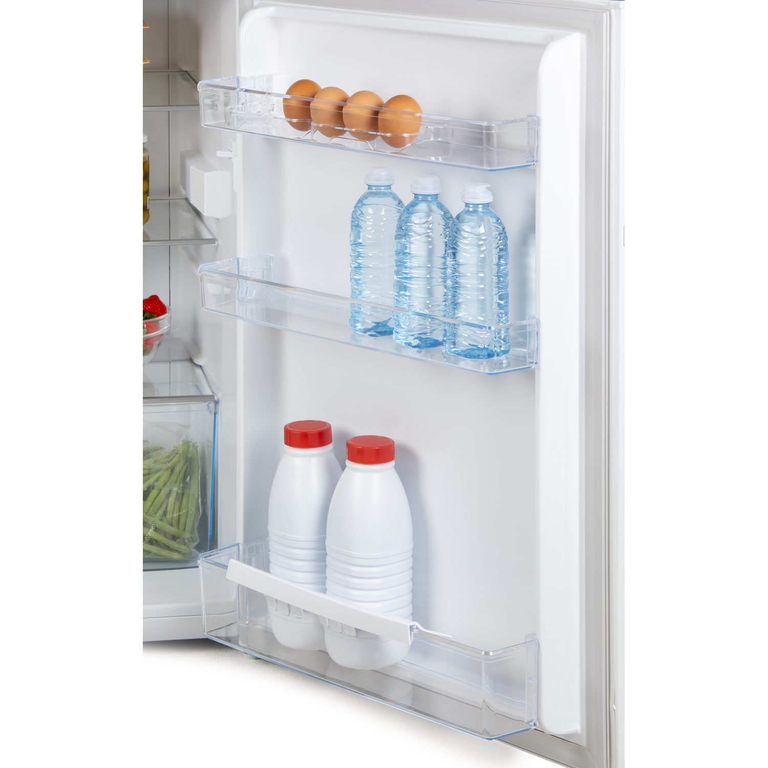 Inside a refrigerator, shelves with eggs, water bottles, and milk bottles. Clear shelves and white interior.