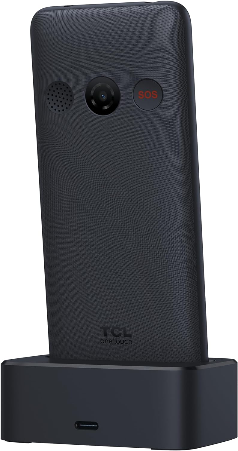 Teléfono móvil negro con botón SOS rojo, en una base de carga.